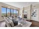 Spacious living room with large windows, a fireplace, and an open floor plan at 13827 N Sunset Dr, Fountain Hills, AZ 85268