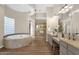 Open-concept main bathroom with dual vanities, large tub, and glass block window at 13827 N Sunset Dr, Fountain Hills, AZ 85268