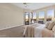 Large main bedroom with sitting area, fireplace, and view of desert landscaping at 13827 N Sunset Dr, Fountain Hills, AZ 85268