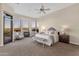 Spacious main bedroom with fireplace, sitting area and large windows with desert views at 13827 N Sunset Dr, Fountain Hills, AZ 85268