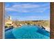 This backyard is complete with a beautiful waterfall feature that flows into the pool, enhancing outdoor ambiance at 13827 N Sunset Dr, Fountain Hills, AZ 85268