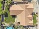 An aerial view shows the house with the tile roof, swimming pool, and grassy back yard at 14955 N 78Th Dr, Peoria, AZ 85381