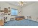 Bedroom featuring ceiling fan, blue carpet, and a window with blind at 14955 N 78Th Dr, Peoria, AZ 85381