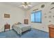 Bedroom featuring ceiling fan, blue carpet, and a window with blind at 14955 N 78Th Dr, Peoria, AZ 85381