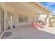 Covered patio features a concrete floor, and a red plastic table and chairs at 14955 N 78Th Dr, Peoria, AZ 85381