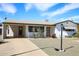Charming single-story home featuring a well-maintained front yard and covered parking at 1510 S Lawther Dr, Apache Junction, AZ 85120