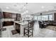 Open-concept kitchen with island seating seamlessly connects to the living area, perfect for entertaining at 15262 W Garfield St, Goodyear, AZ 85338