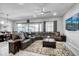 Spacious living room features tile floors, a ceiling fan, and a comfortable sectional sofa at 15262 W Garfield St, Goodyear, AZ 85338