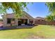 Sprawling backyard with covered patio, brick pavers, lush lawn, and privacy fence at 16966 W Rio Vista Ln, Goodyear, AZ 85338