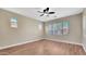 Cozy bedroom with wood floors, ceiling fan, and bright windows at 16966 W Rio Vista Ln, Goodyear, AZ 85338