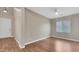 Open bedroom featuring hardwood floors, a ceiling fan, and bright windows at 16966 W Rio Vista Ln, Goodyear, AZ 85338