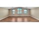 Spacious bedroom featuring hardwood floors and multiple windows allowing for natural light at 16966 W Rio Vista Ln, Goodyear, AZ 85338