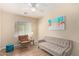 Relaxing bedroom featuring light color palette with ceiling fan and window offering natural light at 16966 W Rio Vista Ln, Goodyear, AZ 85338