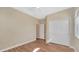 Light bedroom with a ceiling fan, hardwood floors, and white closet doors at 16966 W Rio Vista Ln, Goodyear, AZ 85338