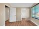 Bright bedroom with hardwood floors, neutral walls, and natural light from the window at 16966 W Rio Vista Ln, Goodyear, AZ 85338