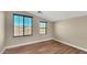 Bedroom featuring hardwood floors and two sunny windows at 16966 W Rio Vista Ln, Goodyear, AZ 85338