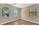 Cozy bedroom with a ceiling fan, hardwood floors, and sunny windows at 16966 W Rio Vista Ln, Goodyear, AZ 85338