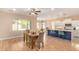 Bright dining area with a large window and wood-look flooring at 16966 W Rio Vista Ln, Goodyear, AZ 85338