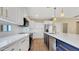 Modern kitchen featuring white cabinets, stainless steel appliances, and an island with a sink at 16966 W Rio Vista Ln, Goodyear, AZ 85338