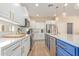 Beautiful kitchen with white cabinets, quartz countertops, and stainless steel appliances at 16966 W Rio Vista Ln, Goodyear, AZ 85338