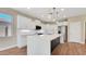 Open kitchen with a large island, stainless steel appliances, and stylish pendant lighting at 16966 W Rio Vista Ln, Goodyear, AZ 85338