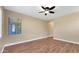 Open living room featuring wood floors, ceiling fan, and a bright window at 16966 W Rio Vista Ln, Goodyear, AZ 85338
