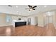 Bright, open living area with hardwood floors, ceiling fan, and seamless access to the kitchen at 16966 W Rio Vista Ln, Goodyear, AZ 85338