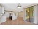 Open-concept living space with hardwood floors, modern lighting, and sliding glass doors to the patio at 16966 W Rio Vista Ln, Goodyear, AZ 85338