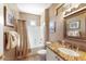 Bathroom featuring a bathtub/shower combination, single sink, and decorative mirror at 17204 W Cordova Ct, Surprise, AZ 85387