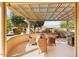 Covered patio with shade lattice, outdoor seating, and barbecue area for outdoor entertaining at 17204 W Cordova Ct, Surprise, AZ 85387