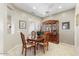 Cozy dining room features wood table with seating for four next to a gorgeous china cabinet at 17204 W Cordova Ct, Surprise, AZ 85387