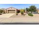 Charming home featuring desert landscaping, a two-car garage, and a well-maintained front yard at 17204 W Cordova Ct, Surprise, AZ 85387
