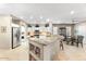 Bright kitchen featuring granite countertops, stainless steel appliances, and a breakfast bar at 17204 W Cordova Ct, Surprise, AZ 85387