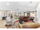 Spacious open-concept living room, seamlessly connected to the kitchen and dining areas with neutral tones at 17204 W Cordova Ct, Surprise, AZ 85387