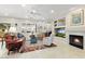 Comfortable living room with fireplace, bright light, ceiling fan and calm neutral tones at 17204 W Cordova Ct, Surprise, AZ 85387
