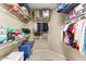 Walk-in closet with built-in shelving and hanging racks for organized storage at 17204 W Cordova Ct, Surprise, AZ 85387