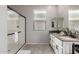 Stylish bathroom with double sinks, a glass-enclosed shower, and tiled floors at 17452 W Andrea Dr, Surprise, AZ 85387