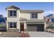 Inviting two-story home featuring a neutral color palette and an attached two-car garage in a picturesque setting at 1828 W Sombra Ave, Apache Junction, AZ 85120