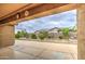 View of the backyard showing a spacious patio, desert landscaping, and privacy fence at 18618 E Mockingbird Dr, Queen Creek, AZ 85142