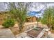Backyard with a desert landscape, patio furniture, and beautiful greenery at 18618 E Mockingbird Dr, Queen Creek, AZ 85142