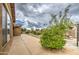 Spacious backyard featuring a desert landscape design and concrete patio at 18618 E Mockingbird Dr, Queen Creek, AZ 85142