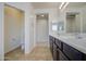 Bright bathroom featuring double sinks, sleek fixtures, and a separate toilet room for added privacy at 18618 E Mockingbird Dr, Queen Creek, AZ 85142