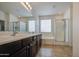 Bathroom features double sinks, dark wood cabinets, soaking tub, and glass shower at 18618 E Mockingbird Dr, Queen Creek, AZ 85142