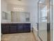 Bathroom boasts double sinks, dark wood cabinets, a soaking tub, and glass shower at 18618 E Mockingbird Dr, Queen Creek, AZ 85142
