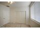 Bright bedroom with neutral carpet, window, and sliding closet doors offering ample storage space at 18618 E Mockingbird Dr, Queen Creek, AZ 85142