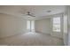 Large, bright bedroom with neutral carpet and multiple windows with blinds at 18618 E Mockingbird Dr, Queen Creek, AZ 85142