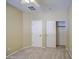 Bedroom with neutral carpet, ceiling fan, and closet; a comfortable and functional space for rest at 18618 E Mockingbird Dr, Queen Creek, AZ 85142