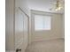 Cozy bedroom with neutral carpet, ceiling fan, and sliding closet doors for efficient space utilization at 18618 E Mockingbird Dr, Queen Creek, AZ 85142