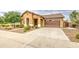 Charming single-story home with a well-maintained lawn and a two car garage and covered entry at 18618 E Mockingbird Dr, Queen Creek, AZ 85142