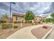 Cozy single-story home with xeriscaping, mature trees, and a well-manicured lawn on a quiet street at 18618 E Mockingbird Dr, Queen Creek, AZ 85142